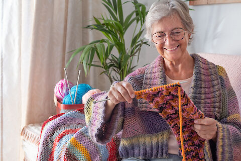 https://www.seniorhelpers.com/site/assets/files/450528/senior-woman-sitting-on-sofa-at-home-while-knitting-crafts.480x0.jpg