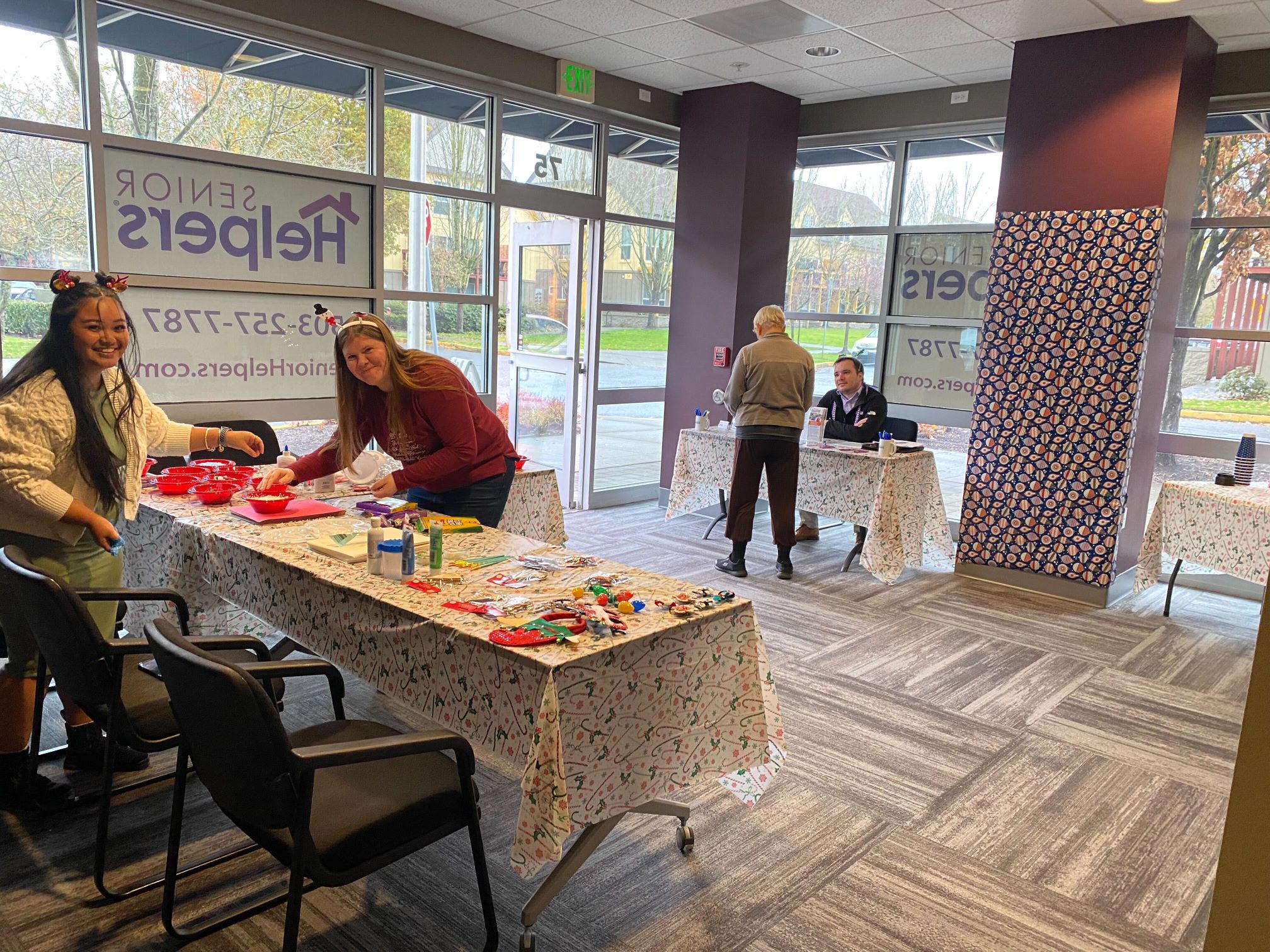 Office Staff Preparing for 2023 Holiday at Russellville Senior Helpers Office Staff Cassandra Coleman and Annjohnette Tubera work together to set up the holiday craft table for our caregivers and Russellville residents to enjoy!