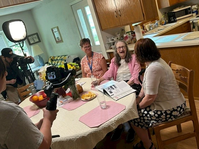 Director, caregiver and client filming commercial